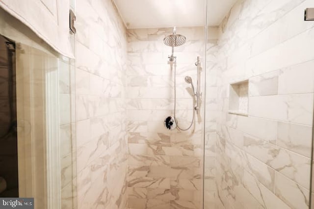 bathroom with a tile shower