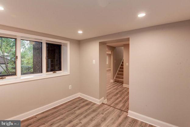 spare room with wood-type flooring