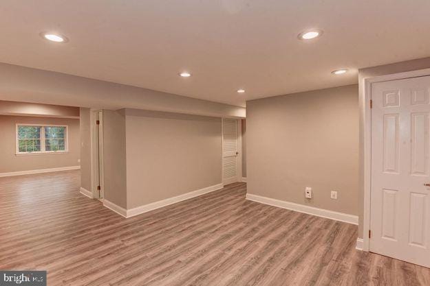 basement with hardwood / wood-style floors