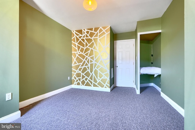 unfurnished bedroom featuring carpet and a closet