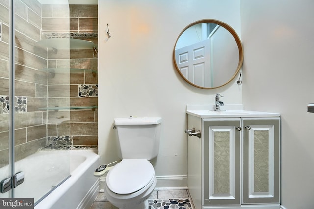 full bathroom featuring toilet, tiled shower / bath, tile patterned floors, and vanity