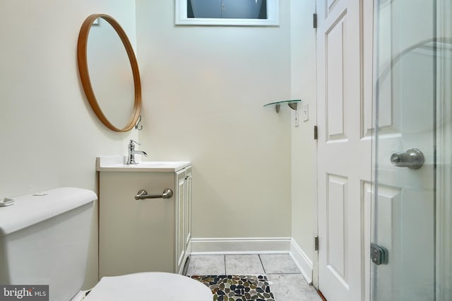 bathroom featuring toilet, vanity, and tile patterned flooring