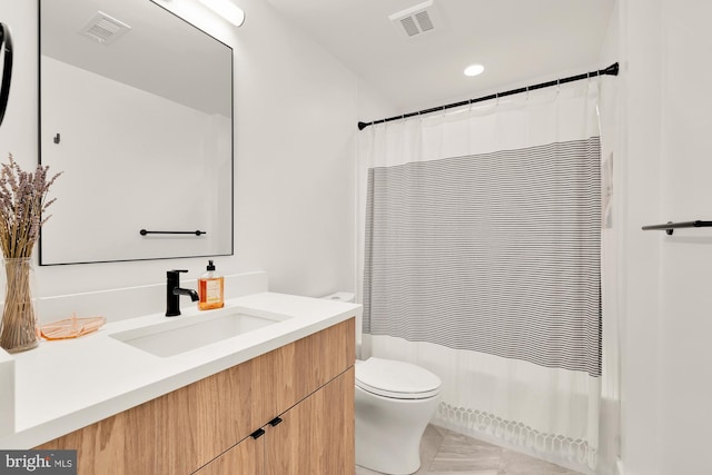 bathroom featuring toilet and vanity