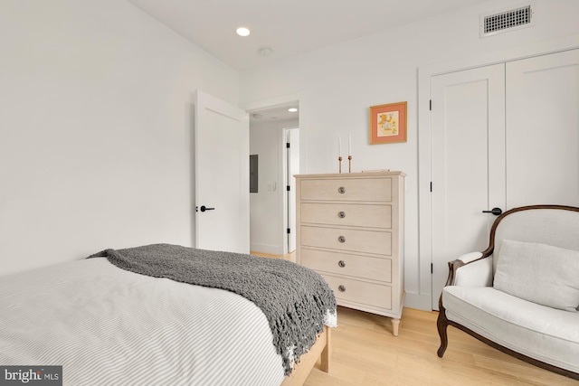 bedroom with a closet and light hardwood / wood-style floors