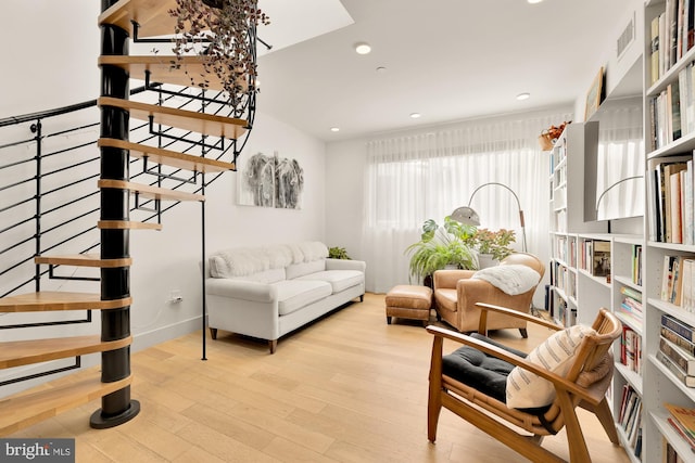 living area featuring light hardwood / wood-style floors and plenty of natural light