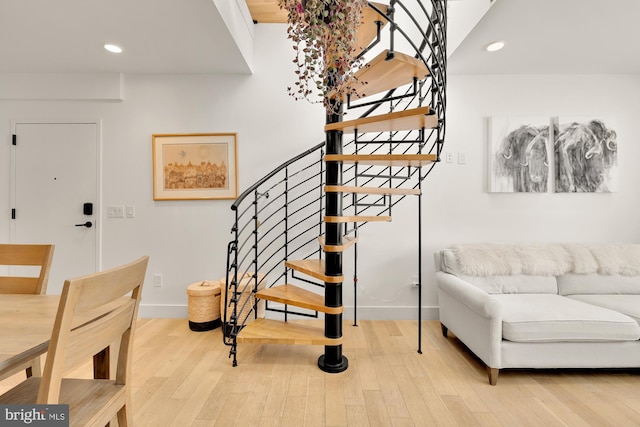 stairway with hardwood / wood-style floors