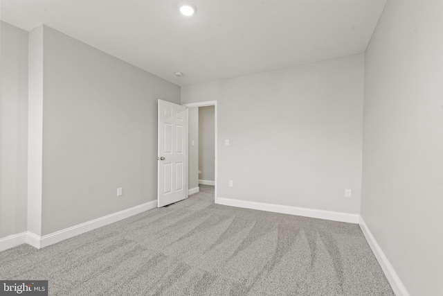 empty room featuring light carpet