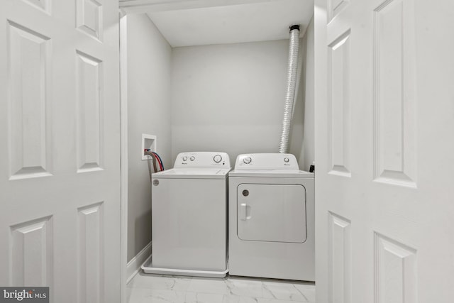 clothes washing area featuring independent washer and dryer