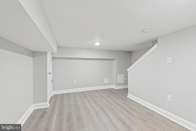 basement with light hardwood / wood-style floors