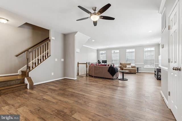 living room featuring ceiling fan, wood-type flooring, and crown molding