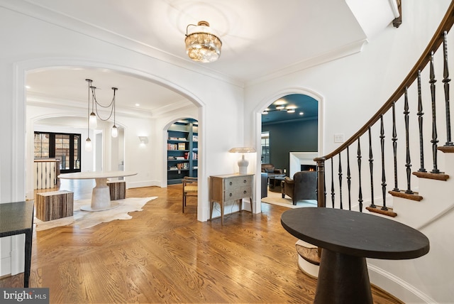 entrance foyer featuring ornamental molding and a notable chandelier