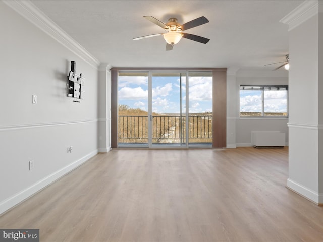 unfurnished living room with light hardwood / wood-style flooring, ornamental molding, floor to ceiling windows, and ceiling fan