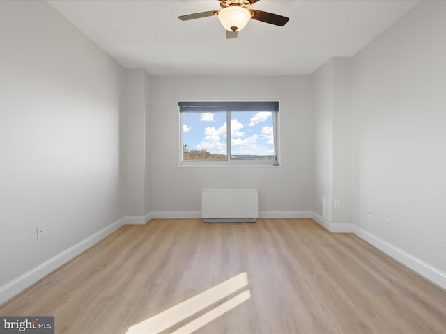 spare room with ceiling fan and light hardwood / wood-style flooring