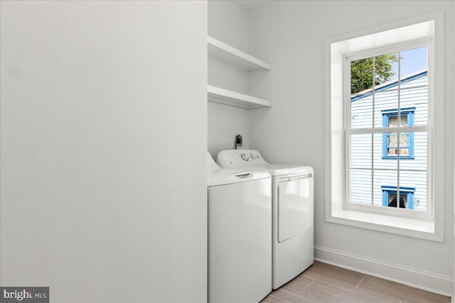 1631 U St SE, Washington, DC 20020 - laundry room featuring washing machine and dryer and light wood-style flooring