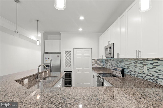 1631 U St SE, Washington, DC 20020 - kitchen with stainless steel appliances, wine cooler, ornamental molding, decorative backsplash, and pendant lighting