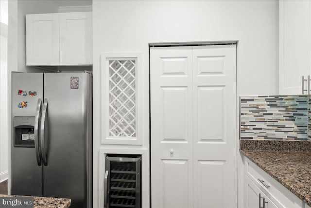 1631 U St SE, Washington, DC 20020 - kitchen featuring stainless steel fridge with ice dispenser, wine cooler, tasteful backsplash, white cabinetry, and dark stone counters