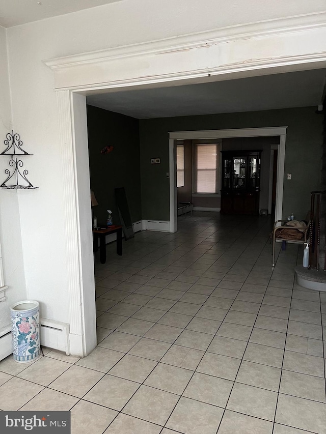 interior space with baseboard heating and light tile patterned floors