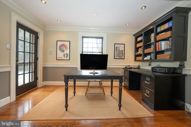 office space featuring french doors, ornamental molding, and light hardwood / wood-style flooring