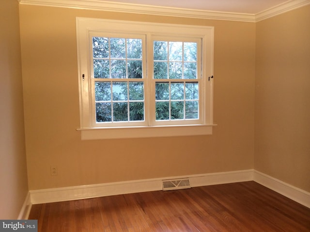 empty room featuring crown molding and hardwood / wood-style floors