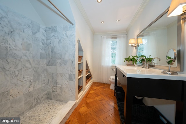 bathroom with toilet, vanity, parquet floors, and ornamental molding