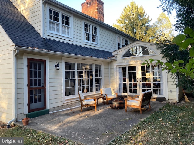 back of house with an outdoor fire pit, french doors, and a patio