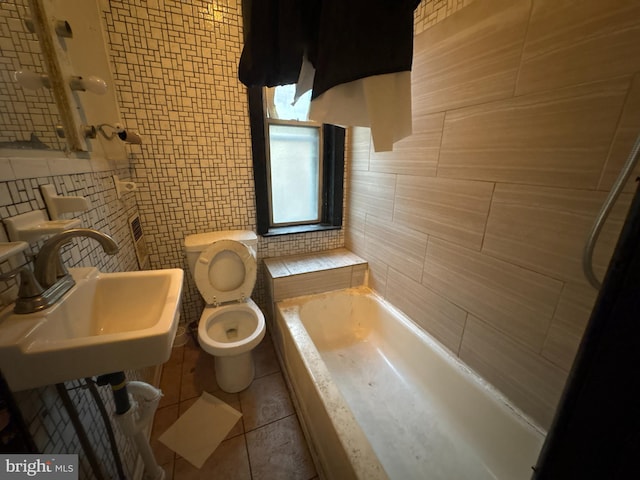 full bathroom featuring tile patterned flooring, washtub / shower combination, sink, tile walls, and toilet