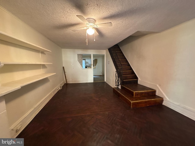 interior space featuring parquet floors and a textured ceiling