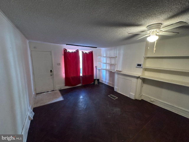 interior space with a textured ceiling and ceiling fan