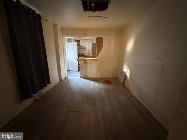 corridor with hardwood / wood-style flooring