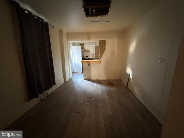 hallway with hardwood / wood-style floors