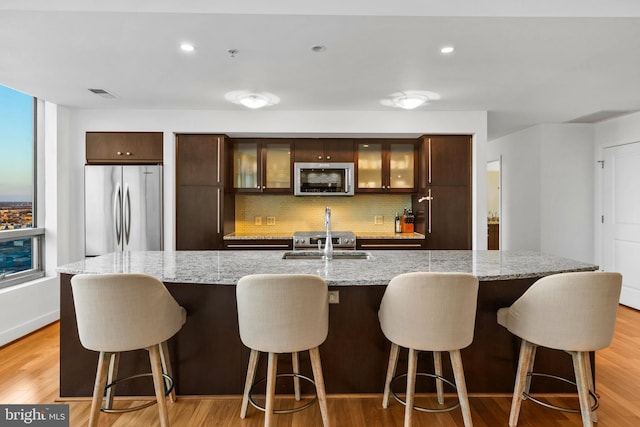 kitchen featuring appliances with stainless steel finishes, a kitchen bar, and a spacious island