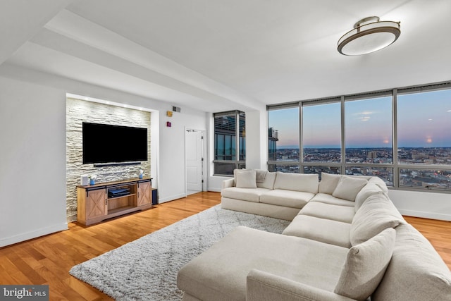 living room featuring a wall of windows and hardwood / wood-style flooring