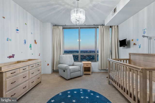 bedroom featuring light colored carpet, a notable chandelier, a crib, and floor to ceiling windows