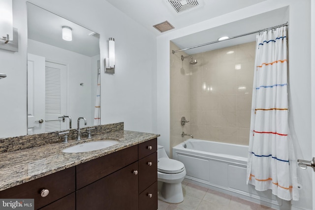 full bathroom featuring toilet, tile patterned floors, vanity, and shower / bath combo with shower curtain