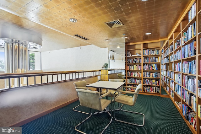 carpeted office space featuring built in shelves