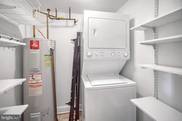 washroom featuring stacked washer and clothes dryer and water heater