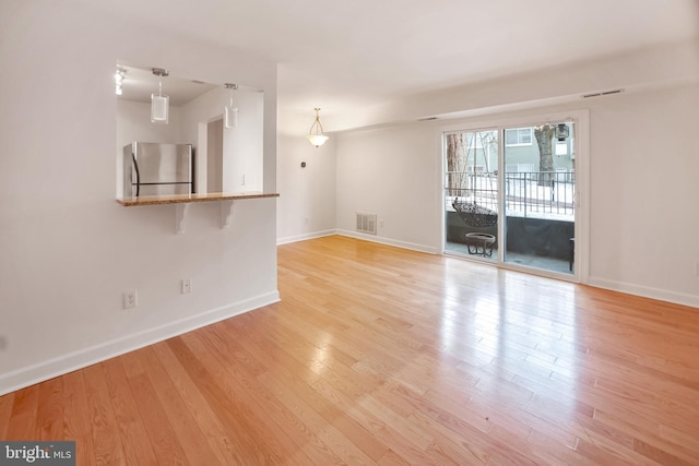 unfurnished living room with light hardwood / wood-style flooring