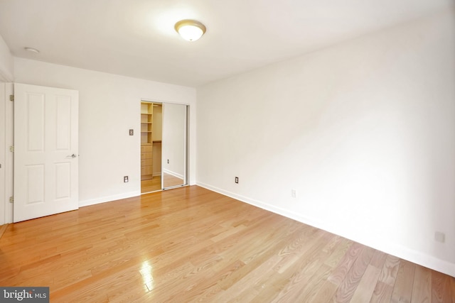 unfurnished bedroom with a closet and hardwood / wood-style floors