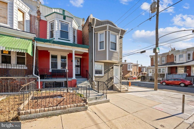 townhome / multi-family property featuring a porch