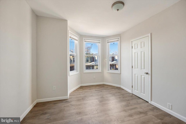 spare room with light hardwood / wood-style flooring