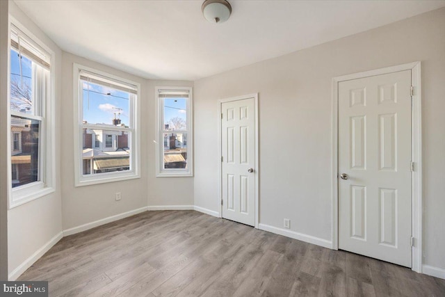 unfurnished bedroom featuring light wood-type flooring