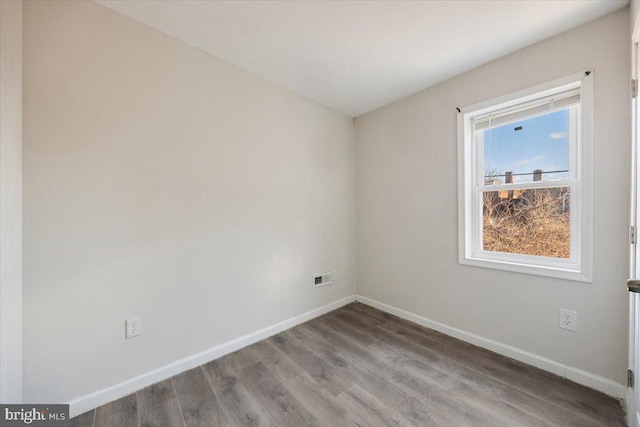 spare room featuring hardwood / wood-style flooring