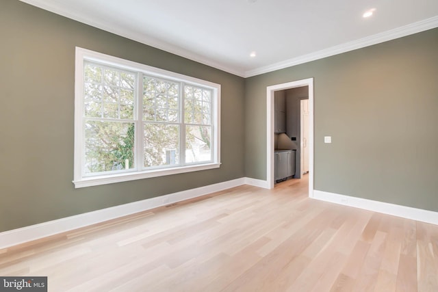 unfurnished room featuring crown molding and light hardwood / wood-style floors