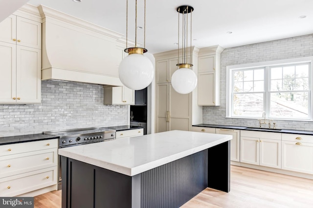 kitchen featuring a kitchen island, backsplash, and hanging light fixtures