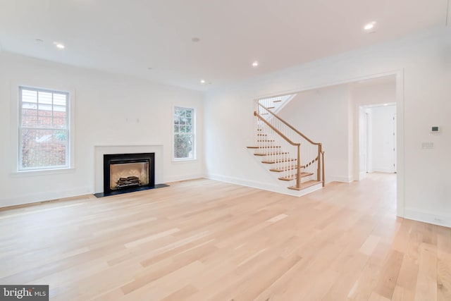 unfurnished living room featuring light hardwood / wood-style flooring