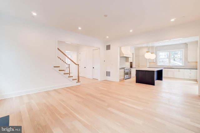 unfurnished living room with light hardwood / wood-style flooring