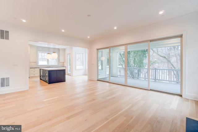 unfurnished living room featuring light wood-type flooring