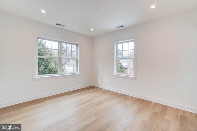 spare room with light hardwood / wood-style flooring