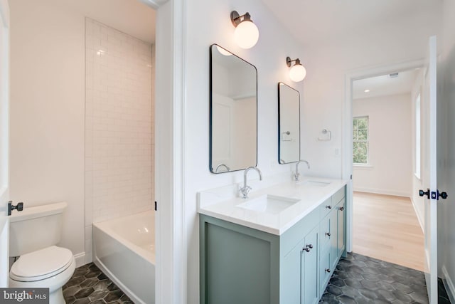 full bathroom featuring tiled shower / bath combo, tile patterned floors, vanity, and toilet