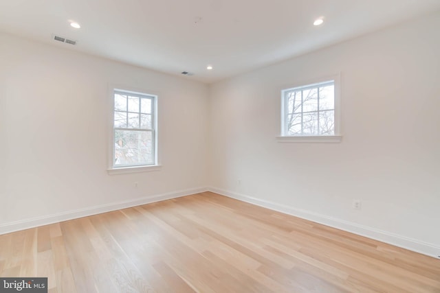 unfurnished room featuring a healthy amount of sunlight and light hardwood / wood-style flooring